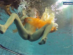 Yellow and red clothed teen underwater